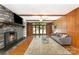 Spacious living room with a stone fireplace and access to a large deck at 1107 Fairfield Dr, Gastonia, NC 28054