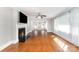 Bright living room with a fireplace, hardwood floors, and large windows at 1107 Fairfield Dr, Gastonia, NC 28054