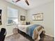 Comfortable bedroom with a ceiling fan, plush carpet, and a bright window at 1132 Whitby Moore St, Charlotte, NC 28273