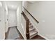 Inviting entryway featuring hardwood floors, staircase, and a white front door at 1132 Whitby Moore St, Charlotte, NC 28273