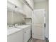 Well-lit laundry area with front load washer and dryer with shelving at 1132 Whitby Moore St, Charlotte, NC 28273
