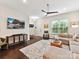 Open-concept living room with lots of natural light, hardwood floors, and a comfortable seating area at 1132 Whitby Moore St, Charlotte, NC 28273