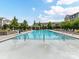 Large community pool with lounge chairs and a covered pavilion for relaxation at 1132 Whitby Moore St, Charlotte, NC 28273