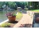 A winding brick path along the lake with lush landscaping and a view of the boat dock at 114 Caraway Ln, Mooresville, NC 28117