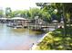 Lakefront home featuring a spacious dock area, boat lift, and lush green landscaping for outdoor enjoyment at 114 Caraway Ln, Mooresville, NC 28117