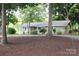 Charming single-story home with mature trees and landscaping creating a serene curb appeal at 114 Caraway Ln, Mooresville, NC 28117