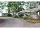 Inviting exterior of a home featuring well-maintained landscaping and a gravel driveway leading to the house at 114 Caraway Ln, Mooresville, NC 28117