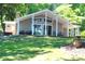 Well-maintained home featuring a covered porch, large windows, and a beautifully landscaped lawn at 114 Caraway Ln, Mooresville, NC 28117