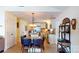 Open-concept kitchen and dining area with white cabinetry, stainless steel appliances, and a breakfast bar at 114 Caraway Ln, Mooresville, NC 28117