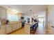 Bright kitchen with white cabinets, granite countertops, and a large island with seating, perfect for entertaining at 114 Caraway Ln, Mooresville, NC 28117