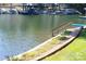 Lakeside access with landscaped path and wooden stairs leading to the water's edge for serene enjoyment at 114 Caraway Ln, Mooresville, NC 28117