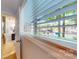 Charming lake view seen through the window of a bathroom with blinds at 114 Caraway Ln, Mooresville, NC 28117