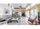 Bright living room with vaulted ceilings, large windows, comfortable seating, and elegant tile flooring at 114 Caraway Ln, Mooresville, NC 28117