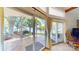 Expansive sliding glass doors open to a serene patio with views of the lake and lush greenery at 114 Caraway Ln, Mooresville, NC 28117