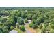 Aerial view of a house nestled among lush trees, showcasing the home's serene and private location at 125 Brasington Ln, Mooresville, NC 28115