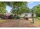 Backyard with deck, patio area and lush trees, perfect for outdoor enjoyment at 125 Brasington Ln, Mooresville, NC 28115