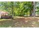 Expansive backyard with lush greenery, mature trees, and a wooden deck perfect for outdoor living at 125 Brasington Ln, Mooresville, NC 28115