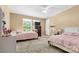 This bedroom has two twin beds with pink bedding, and bright natural light from the large window at 125 Brasington Ln, Mooresville, NC 28115
