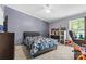 This bedroom boasts a ceiling fan, gray walls, and is decorated with fun toys and games at 125 Brasington Ln, Mooresville, NC 28115