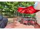 Relax on the deck, shaded by a large umbrella, with a grill and dining set for backyard entertaining at 125 Brasington Ln, Mooresville, NC 28115
