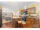 Kitchen features dark wood cabinets, center island and hardwood flooring at 125 Brasington Ln, Mooresville, NC 28115