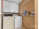 Functional laundry room with ample storage, including overhead cabinets and shelving, alongside a washer and dryer set at 125 Brasington Ln, Mooresville, NC 28115