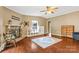 Spacious living room features a charming brick fireplace, hardwood floors, and a bright window at 125 Brasington Ln, Mooresville, NC 28115