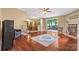 Open living area with a brick fireplace, hardwood floors, and access to an outdoor patio at 125 Brasington Ln, Mooresville, NC 28115