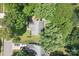 Aerial view of home with mature trees surrounding property, showing roof and driveway at 12524 Angel Oak Dr, Huntersville, NC 28078