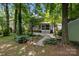 Inviting backyard space with a brick patio, lush landscaping, and charming screened-in porch at 12524 Angel Oak Dr, Huntersville, NC 28078