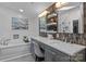 Modern bathroom with double vanity, decorative backsplash, and a luxurious soaking tub at 12524 Angel Oak Dr, Huntersville, NC 28078