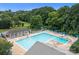 Large community pool with lap lanes and lounge chairs and lush green trees surrounding the area at 12524 Angel Oak Dr, Huntersville, NC 28078
