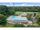 Large community pool with lap lanes, lounge chairs, and additional picnic areas surrounded by lush trees at 12524 Angel Oak Dr, Huntersville, NC 28078