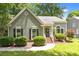 Charming single-story home featuring a well-maintained lawn and classic architectural details at 12524 Angel Oak Dr, Huntersville, NC 28078