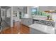 Bright kitchen features stainless appliances, stone countertops, hardwood floors, and a view to the outdoors at 12524 Angel Oak Dr, Huntersville, NC 28078