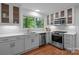 Bright kitchen boasts stainless steel appliances, stone countertops, decorative backsplash and hardwood floors at 12524 Angel Oak Dr, Huntersville, NC 28078