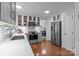 Spacious kitchen with stainless appliances, stone countertops, and view to the dining area; features a pantry at 12524 Angel Oak Dr, Huntersville, NC 28078