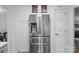 Bright kitchen features stainless steel refrigerator, pantry, and modern cabinetry at 12524 Angel Oak Dr, Huntersville, NC 28078