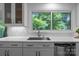 Kitchen with stainless appliances, stone countertops, decorative backsplash and a large window overlooking greenery at 12524 Angel Oak Dr, Huntersville, NC 28078