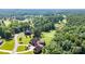 Stunning aerial view of a home on a lush green lot, adjacent to a beautiful golf course at 130 Broken Arrow Dr, Statesville, NC 28677