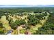 Breathtaking aerial view of a modern home nestled in a golf course community surrounded by lush trees at 130 Broken Arrow Dr, Statesville, NC 28677