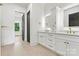 Bright bathroom featuring double vanity with gold hardware and backlit mirrors at 130 Broken Arrow Dr, Statesville, NC 28677