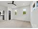 Cozy bedroom with three windows offering natural light and a neutral carpet at 130 Broken Arrow Dr, Statesville, NC 28677
