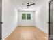 Empty bedroom with hardwood floors, ceiling fan, and natural light at 130 Broken Arrow Dr, Statesville, NC 28677