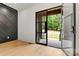 Modern foyer featuring sleek black accent wall, glass front door, and natural light at 130 Broken Arrow Dr, Statesville, NC 28677