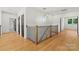 Second floor landing featuring modern chandelier and wood floors at 130 Broken Arrow Dr, Statesville, NC 28677