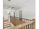 Second floor landing featuring modern chandelier and wood floors at 130 Broken Arrow Dr, Statesville, NC 28677