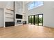 Light-filled living room featuring a modern fireplace, floating shelves, and a wall of windows at 130 Broken Arrow Dr, Statesville, NC 28677