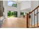 Open-concept living room with high ceilings, natural wood floors, and large glass sliding doors to the backyard at 130 Broken Arrow Dr, Statesville, NC 28677