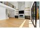 Spacious living room featuring a modern fireplace, floating shelves, and a staircase leading to the second floor at 130 Broken Arrow Dr, Statesville, NC 28677